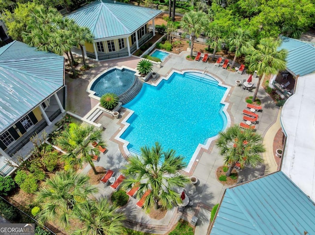 pool featuring a patio area and a hot tub
