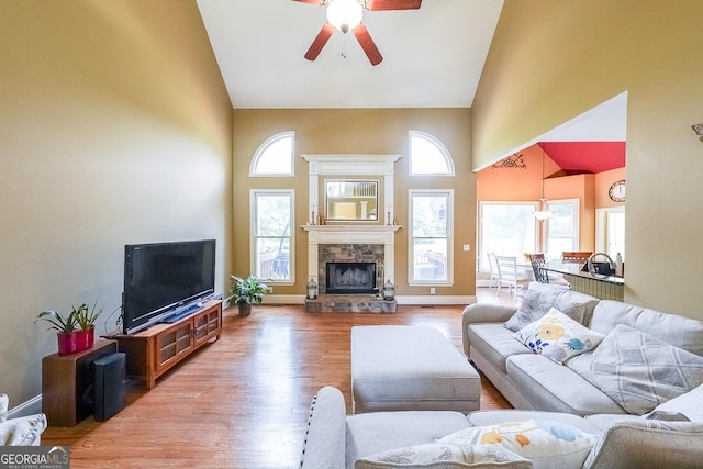 31 Vine Creek Ln, Acworth, GA 30101 - living area with high vaulted ceiling, a ceiling fan, wood finished floors, healthy amount of natural light, and a fireplace
