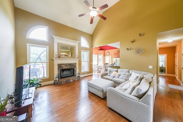 31 Vine Creek Ln, Acworth, GA 30101 - living area with high vaulted ceiling, ceiling fan, wood finished floors, a fireplace, and baseboards