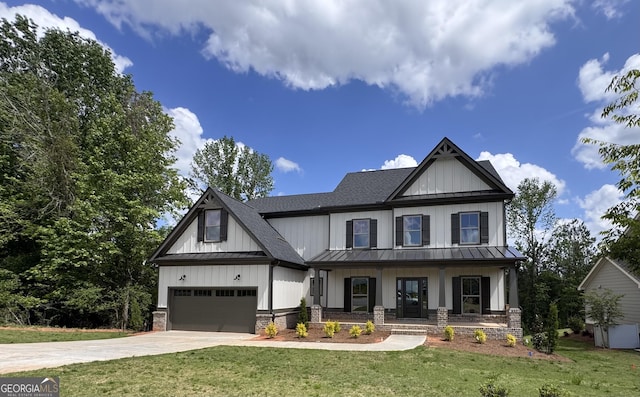 modern farmhouse style home featuring an attached garage, a standing seam roof, board and batten siding, and covered porch