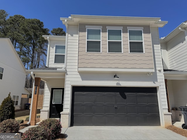 view of front of property with a garage and concrete driveway