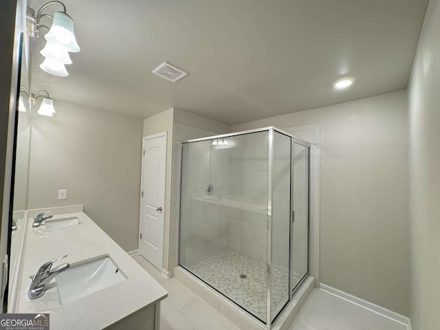 full bath featuring a shower stall, double vanity, a sink, and visible vents