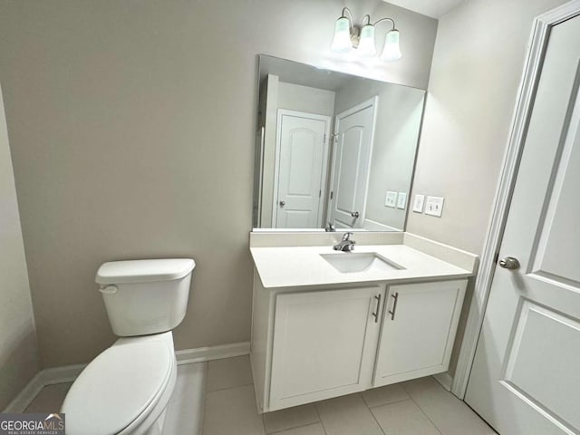 bathroom featuring tile patterned floors, toilet, vanity, and baseboards