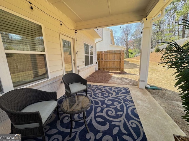 view of patio featuring fence