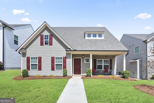 view of front facade with a front yard, a porch, central AC unit, and roof with shingles