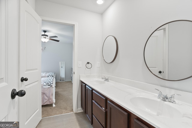 bathroom with double vanity, a sink, and a ceiling fan