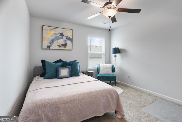 carpeted bedroom with ceiling fan, baseboards, and visible vents