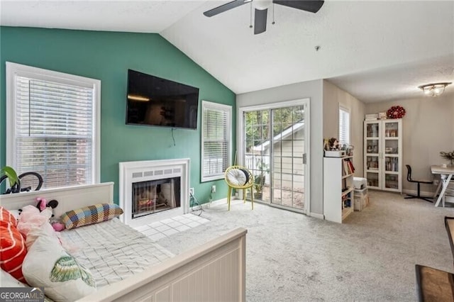 bedroom featuring baseboards, carpet floors, a fireplace with flush hearth, access to exterior, and lofted ceiling