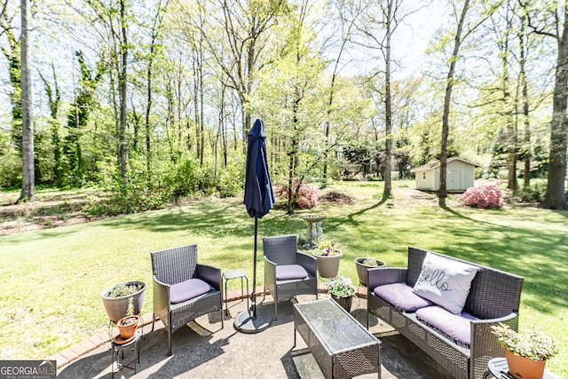 view of patio / terrace with an outdoor living space, an outdoor structure, and a storage unit
