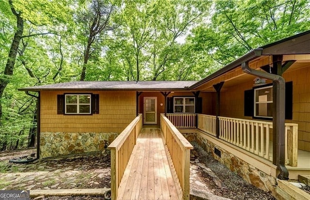 view of front of property with covered porch and stone siding