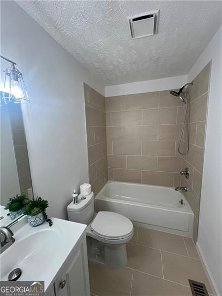 full bathroom featuring visible vents, toilet, tile patterned flooring, and bathing tub / shower combination