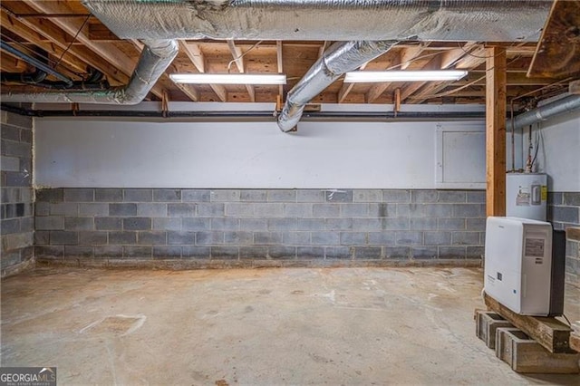 unfinished basement featuring electric water heater