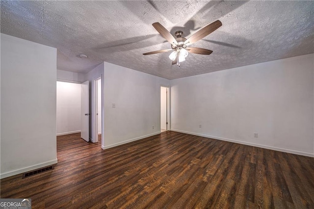 empty room with visible vents, baseboards, ceiling fan, a textured ceiling, and wood finished floors