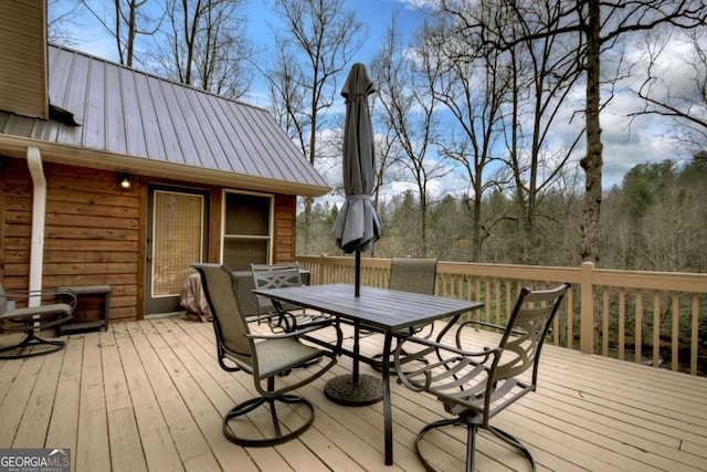 deck with outdoor dining area