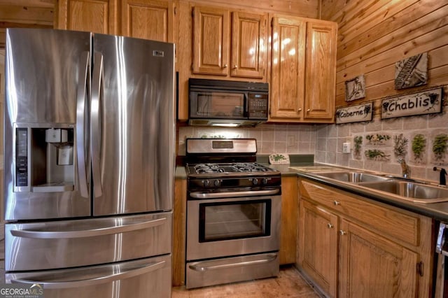 kitchen featuring a sink, decorative backsplash, brown cabinets, and stainless steel appliances