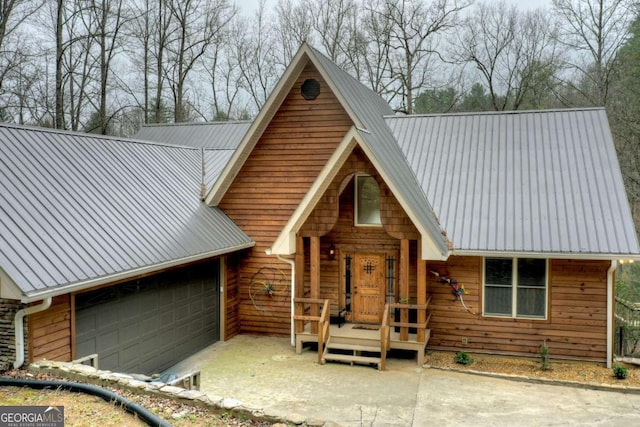 view of front of house featuring a garage and metal roof