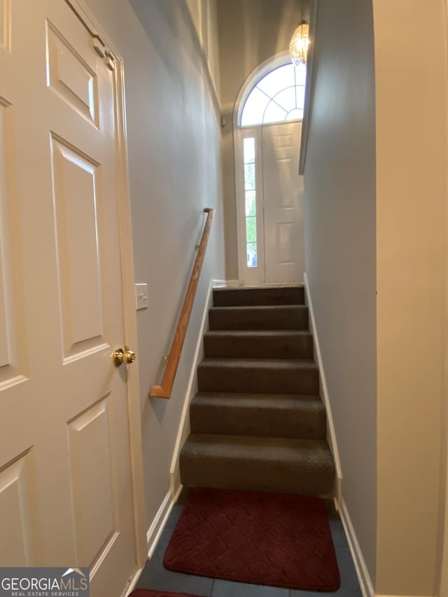 stairs featuring baseboards
