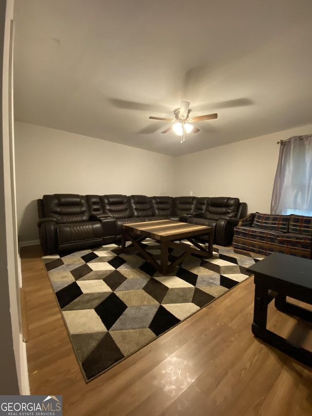 living room with wood finished floors and a ceiling fan