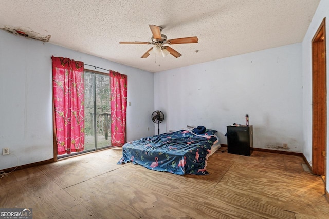 bedroom with a textured ceiling, access to exterior, ceiling fan, and baseboards