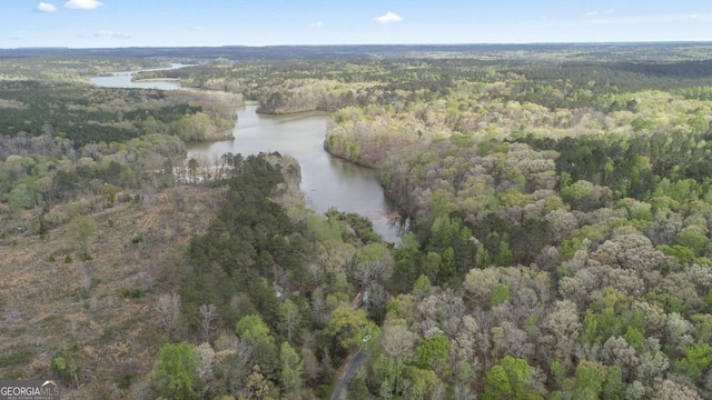 aerial view with a wooded view and a water view