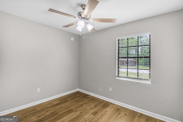 197 Sequoia Cir, Hinesville, GA 31313 - empty room with wood finished floors, ceiling fan, and a textured ceiling