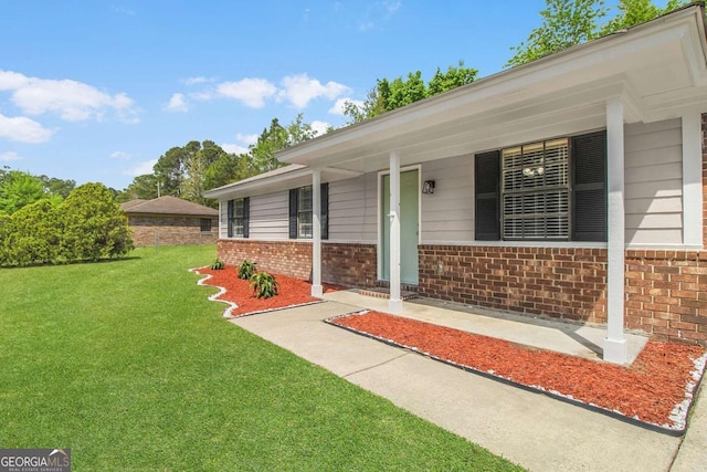 197 Sequoia Cir, Hinesville, GA 31313 - property entrance with brick siding, a lawn, and a porch