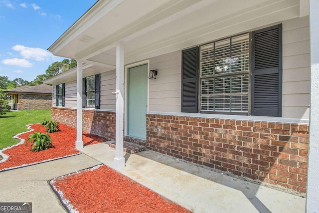 197 Sequoia Cir, Hinesville, GA 31313 - view of exterior entry featuring brick siding and covered porch