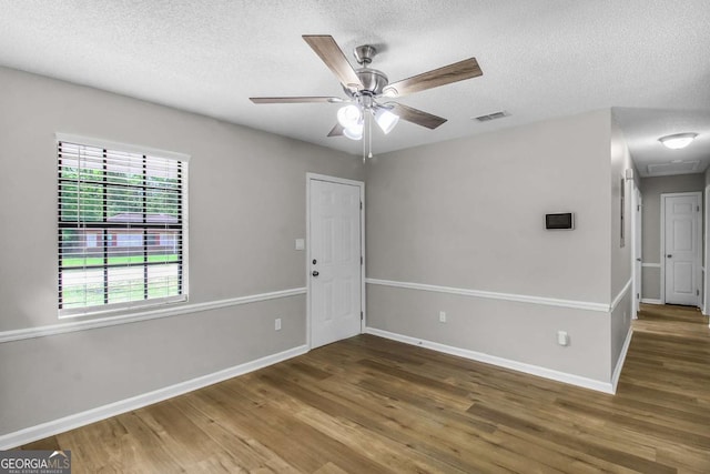 197 Sequoia Cir, Hinesville, GA 31313 - spare room with wood finished floors, a textured ceiling, and a ceiling fan