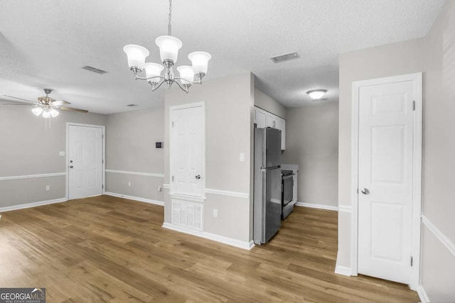 197 Sequoia Cir, Hinesville, GA 31313 - unfurnished dining area featuring a textured ceiling, a chandelier, ceiling fan, and light wood-style flooring