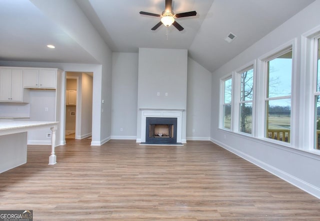 unfurnished living room featuring light wood-type flooring, baseboards, a ceiling fan, and visible vents