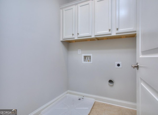 clothes washing area with hookup for a washing machine, hookup for an electric dryer, hookup for a gas dryer, baseboards, and cabinet space