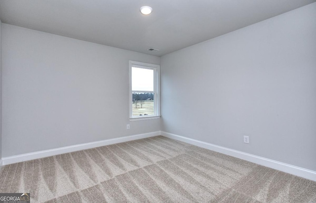 unfurnished room featuring light carpet, recessed lighting, visible vents, and baseboards