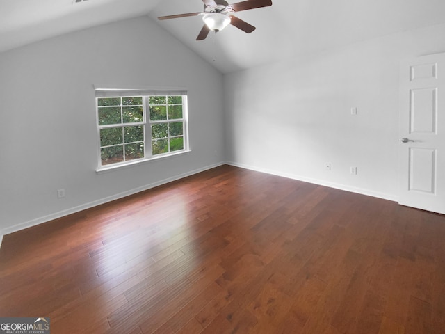 409 Kenley Ct, Mcdonough, GA 30253 - empty room with a ceiling fan, dark wood finished floors, and vaulted ceiling