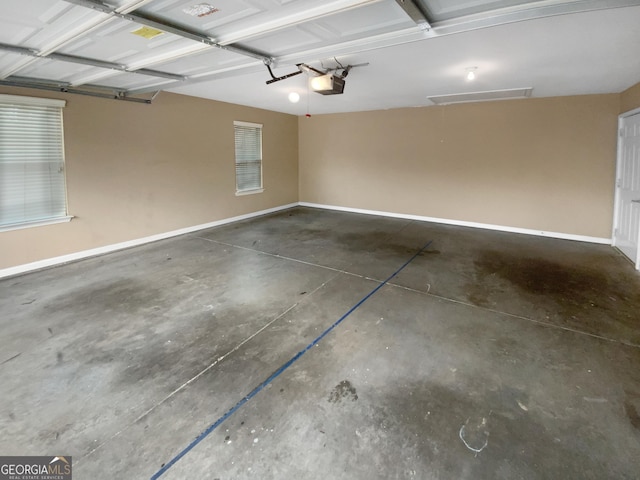 409 Kenley Ct, Mcdonough, GA 30253 - garage featuring a garage door opener and baseboards