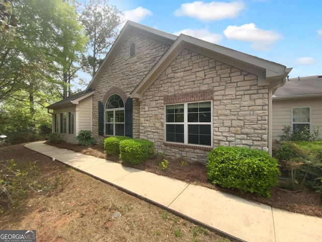 409 Kenley Ct, Mcdonough, GA 30253 - view of side of property featuring stone siding
