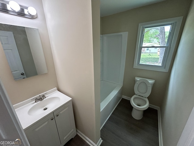 219 Hammerhawk Rd, Griffin, GA 30223 - full bathroom featuring baseboards, toilet, vanity, wood finished floors, and a bathtub
