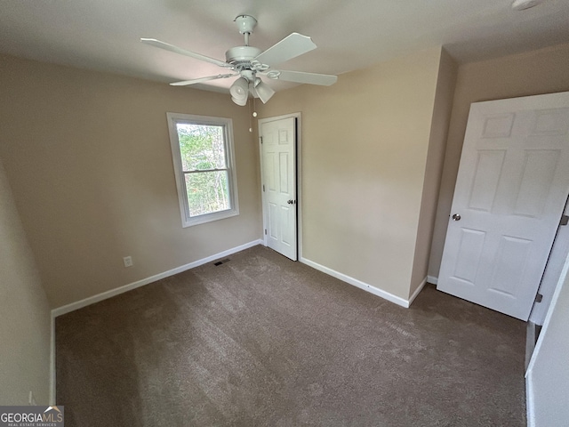 219 Hammerhawk Rd, Griffin, GA 30223 - unfurnished bedroom featuring ceiling fan, a closet, visible vents, dark colored carpet, and baseboards