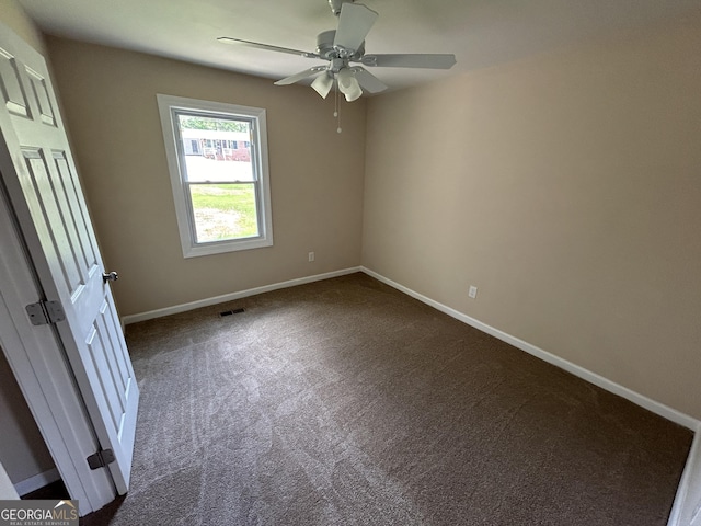 219 Hammerhawk Rd, Griffin, GA 30223 - unfurnished bedroom featuring dark carpet, baseboards, and visible vents