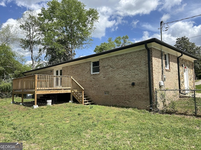219 Hammerhawk Rd, Griffin, GA 30223 - back of house featuring a yard, a wooden deck, fence, and brick siding