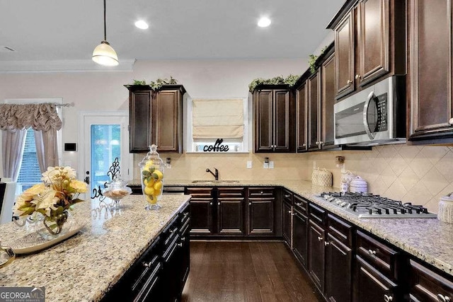 kitchen with stainless steel appliances, dark wood-type flooring, backsplash, and light stone counters