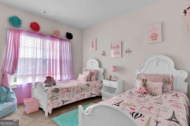 carpeted bedroom featuring visible vents