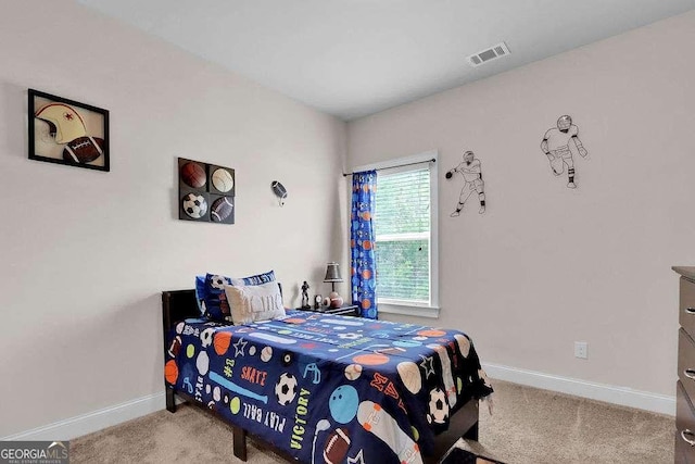 bedroom featuring visible vents, baseboards, and carpet