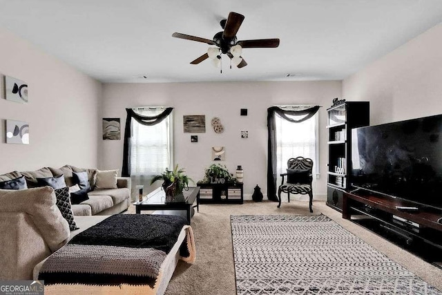 carpeted living room with ceiling fan and a healthy amount of sunlight