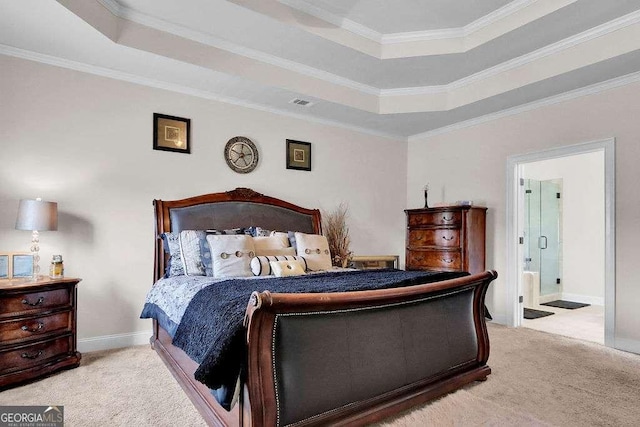 bedroom with a tray ceiling, crown molding, and carpet