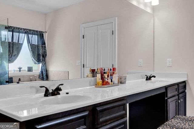 full bath with a sink and double vanity