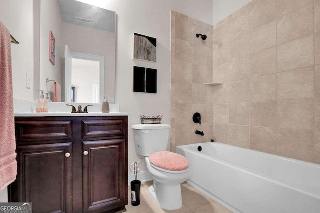 bathroom featuring tile patterned floors, toilet, vanity, and shower / washtub combination
