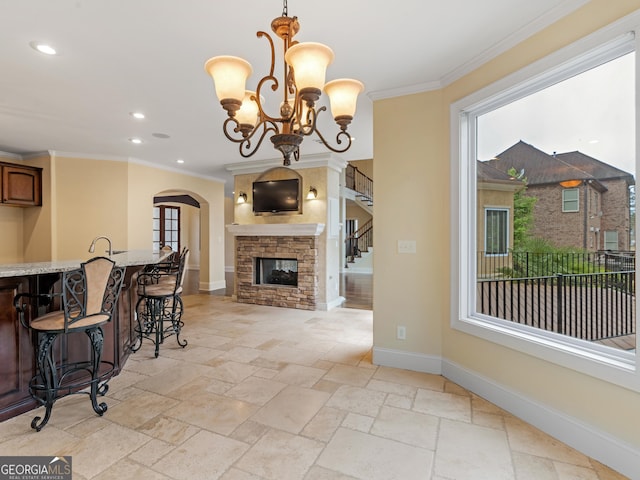 5297 Heron Bay Blvd, Locust Grove, GA 30248 - dining space featuring baseboards, arched walkways, stone tile floors, and crown molding