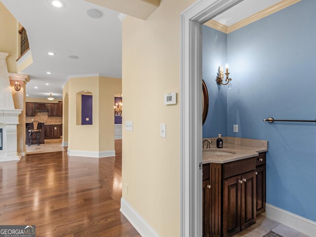5297 Heron Bay Blvd, Locust Grove, GA 30248 - bathroom with crown molding, recessed lighting, wood finished floors, baseboards, and backsplash