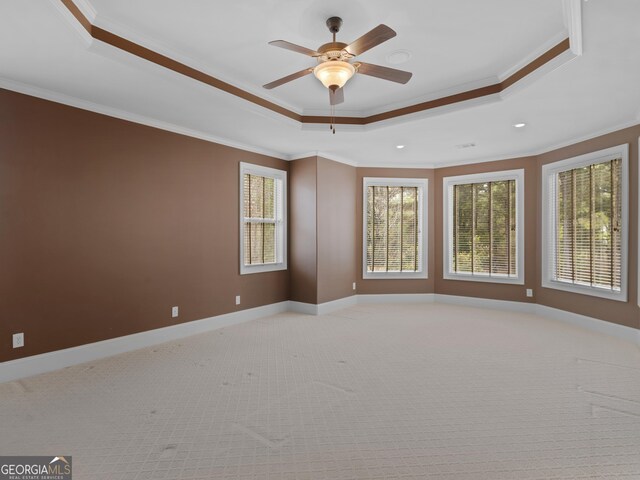 5297 Heron Bay Blvd, Locust Grove, GA 30248 - spare room featuring baseboards, ornamental molding, light carpet, a tray ceiling, and ceiling fan