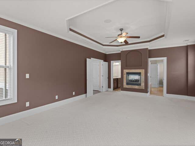 5297 Heron Bay Blvd, Locust Grove, GA 30248 - unfurnished living room featuring baseboards, light carpet, a raised ceiling, crown molding, and ceiling fan